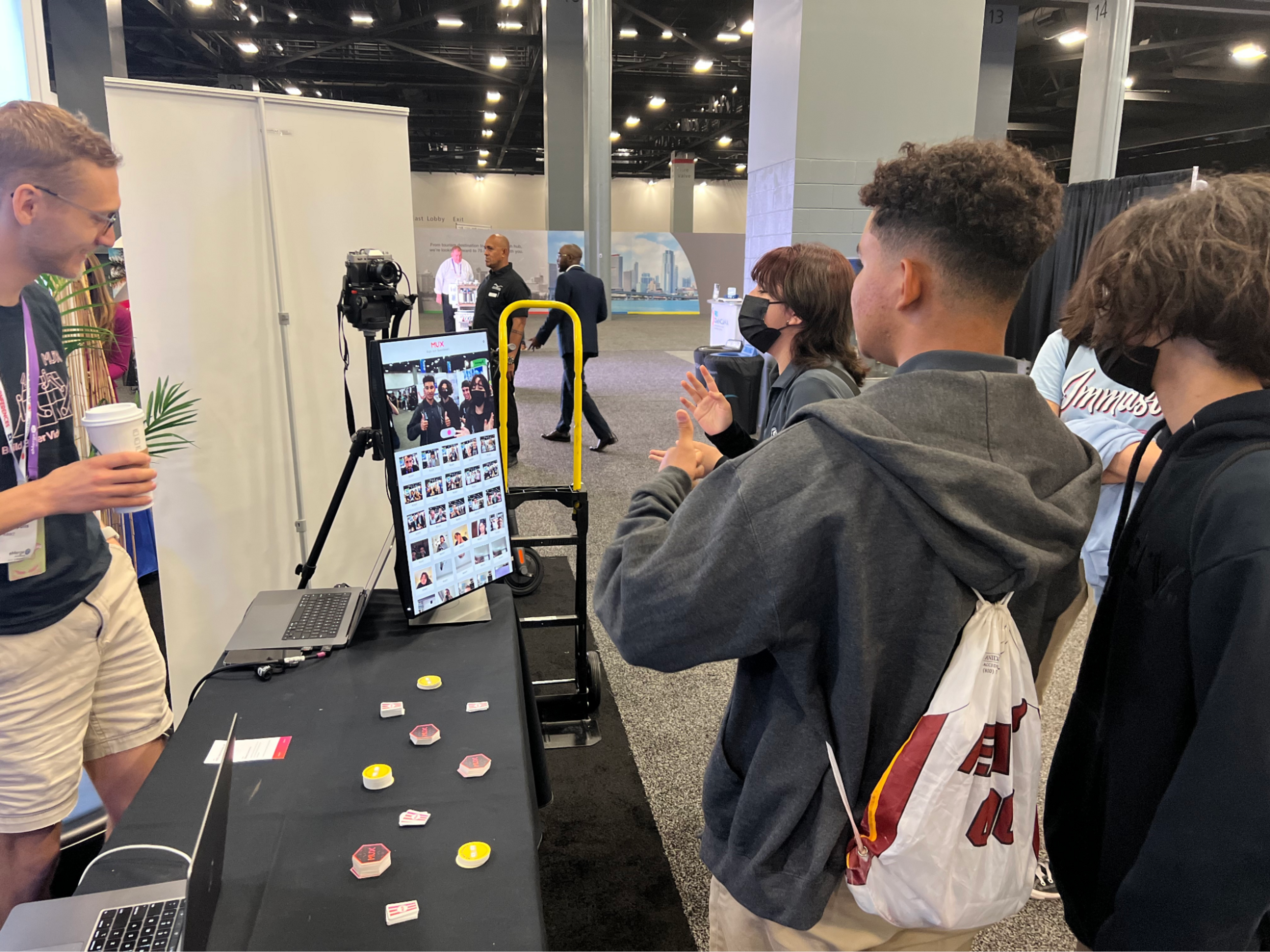 A picture of conference attendees interacting with the video guestbook