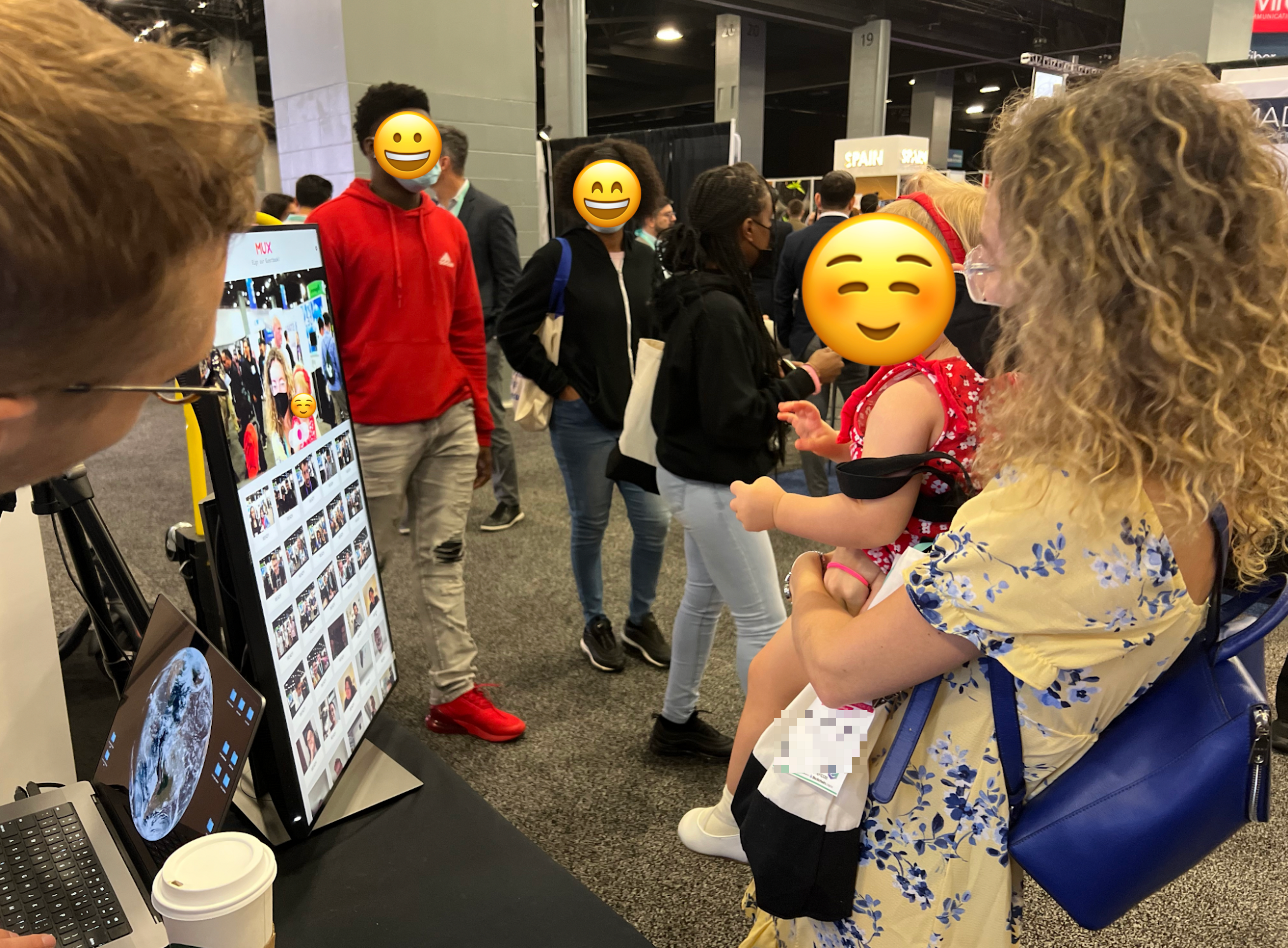 A picture of conference attendees interacting with the video guestbook