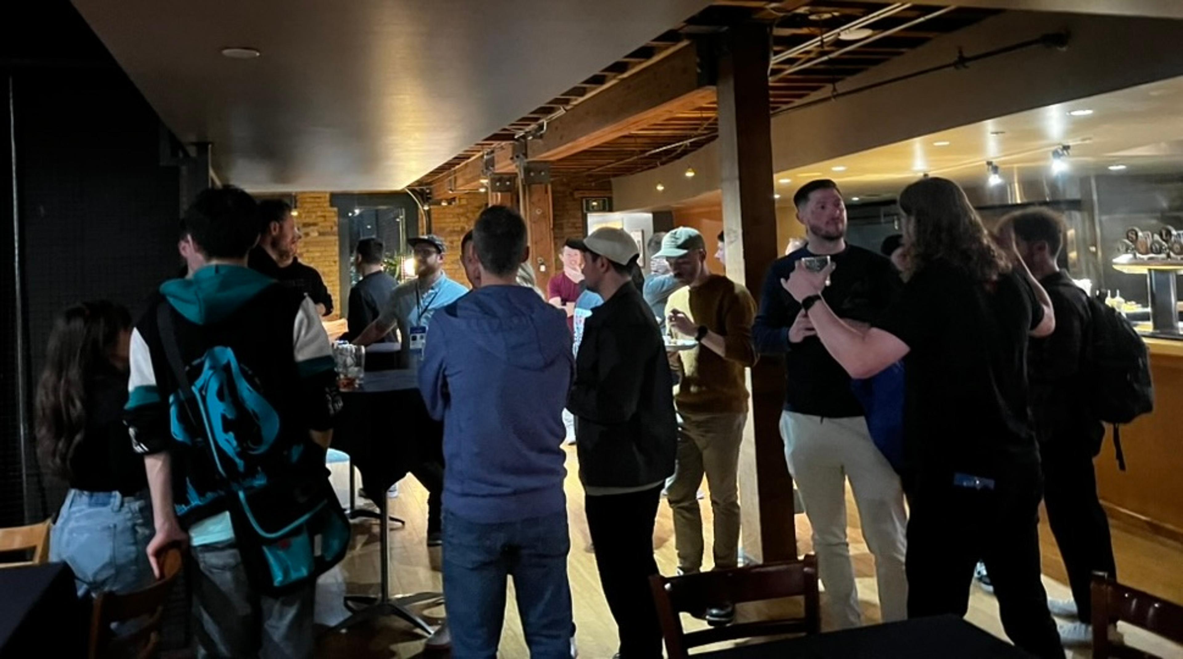A group of attendees mingling at the Epic Web Conf pre-party