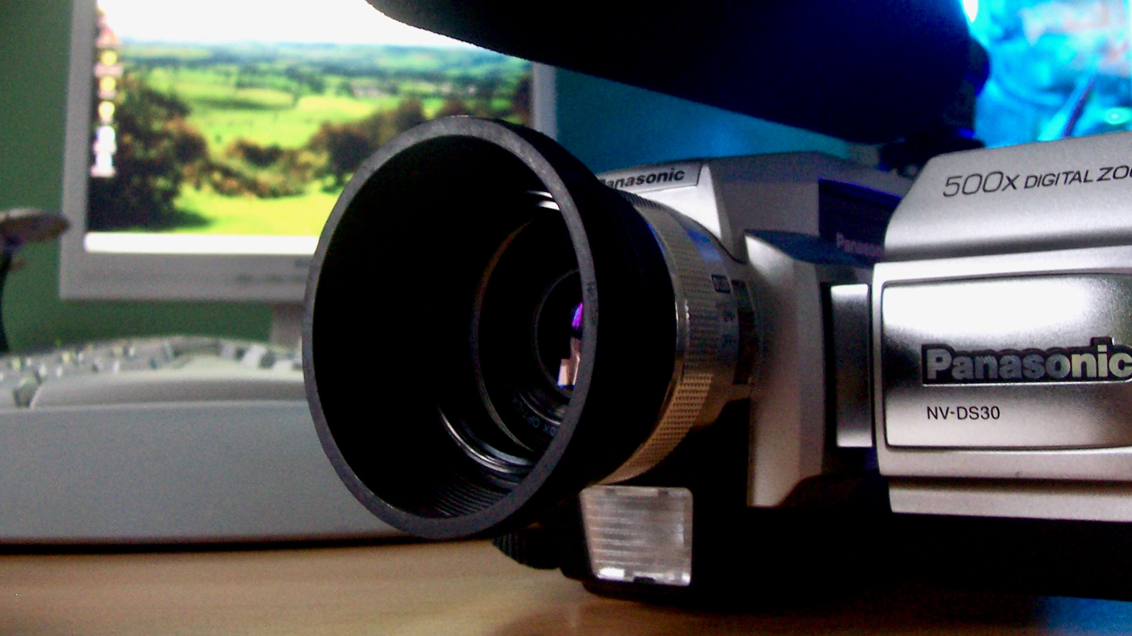 A Panasonic camcorder photographed in front of an early 2000s computer