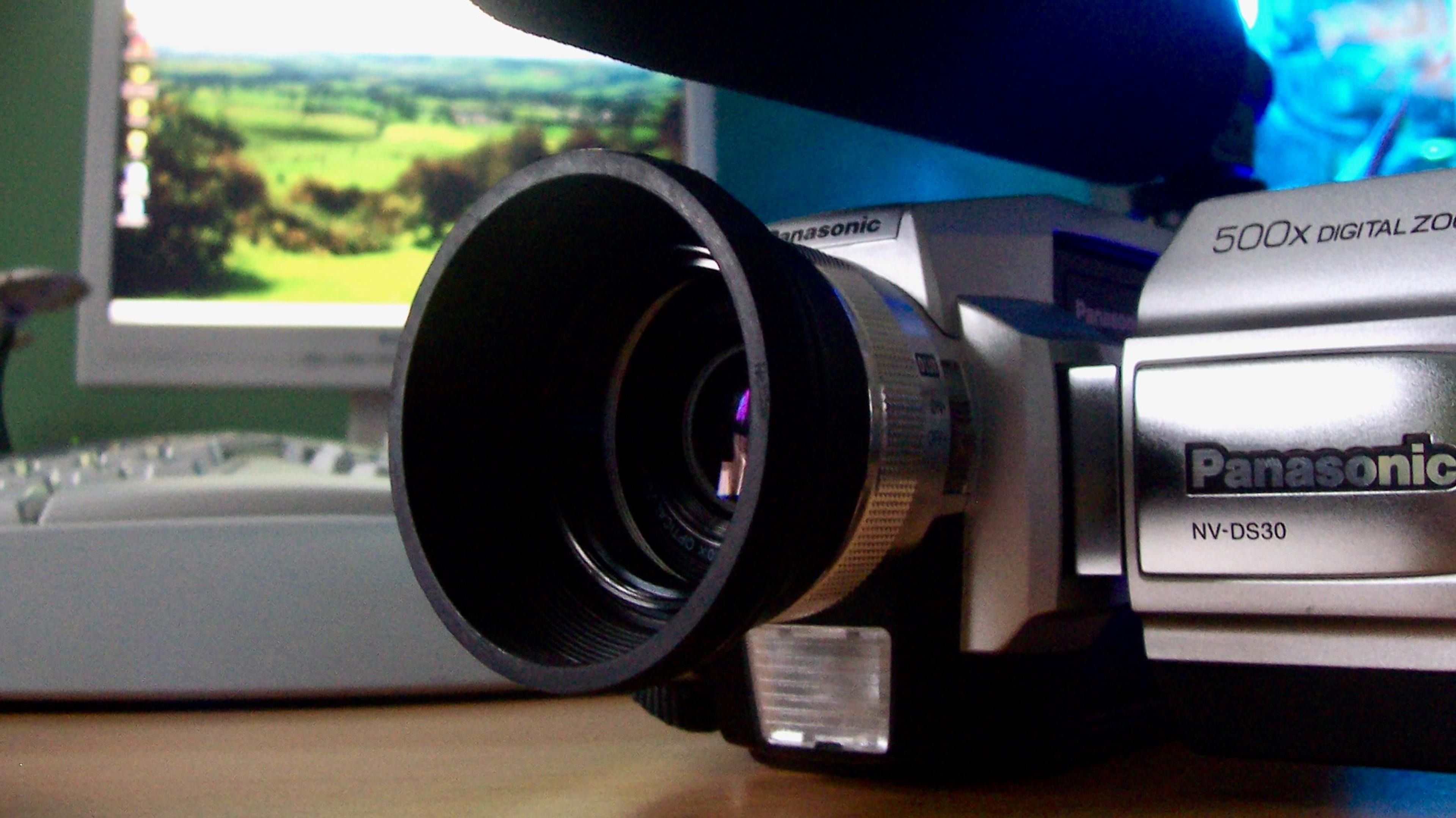 A Panasonic camcorder photographed in front of an early 2000s computer