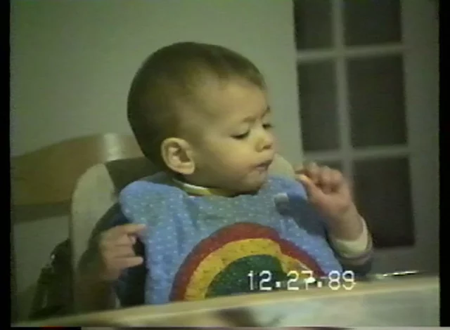 baby eating at a high chair
