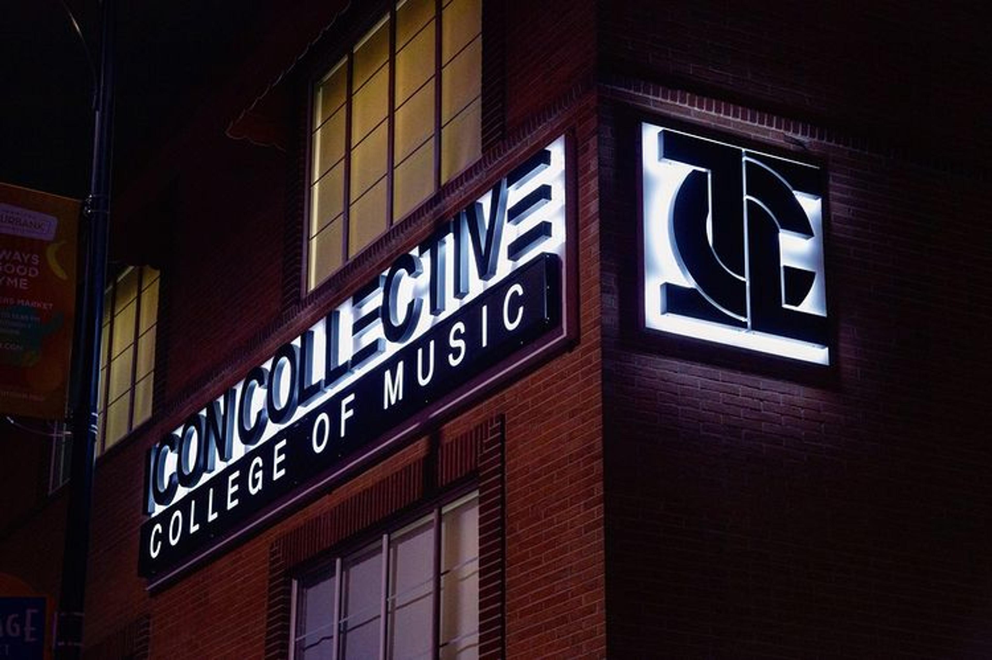 A photograph of the Icon Collective College of Music building exterior at night