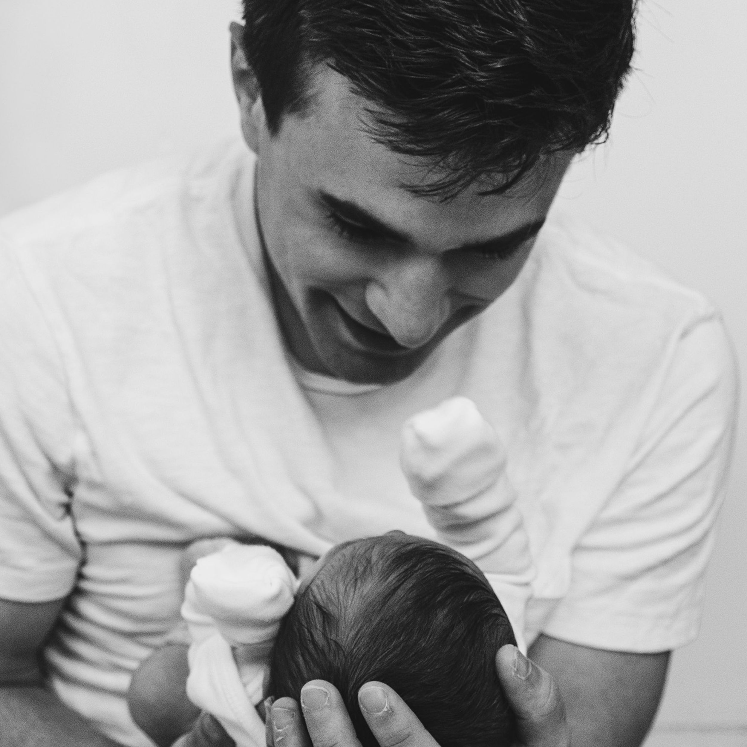 Dad holding baby and smiling
