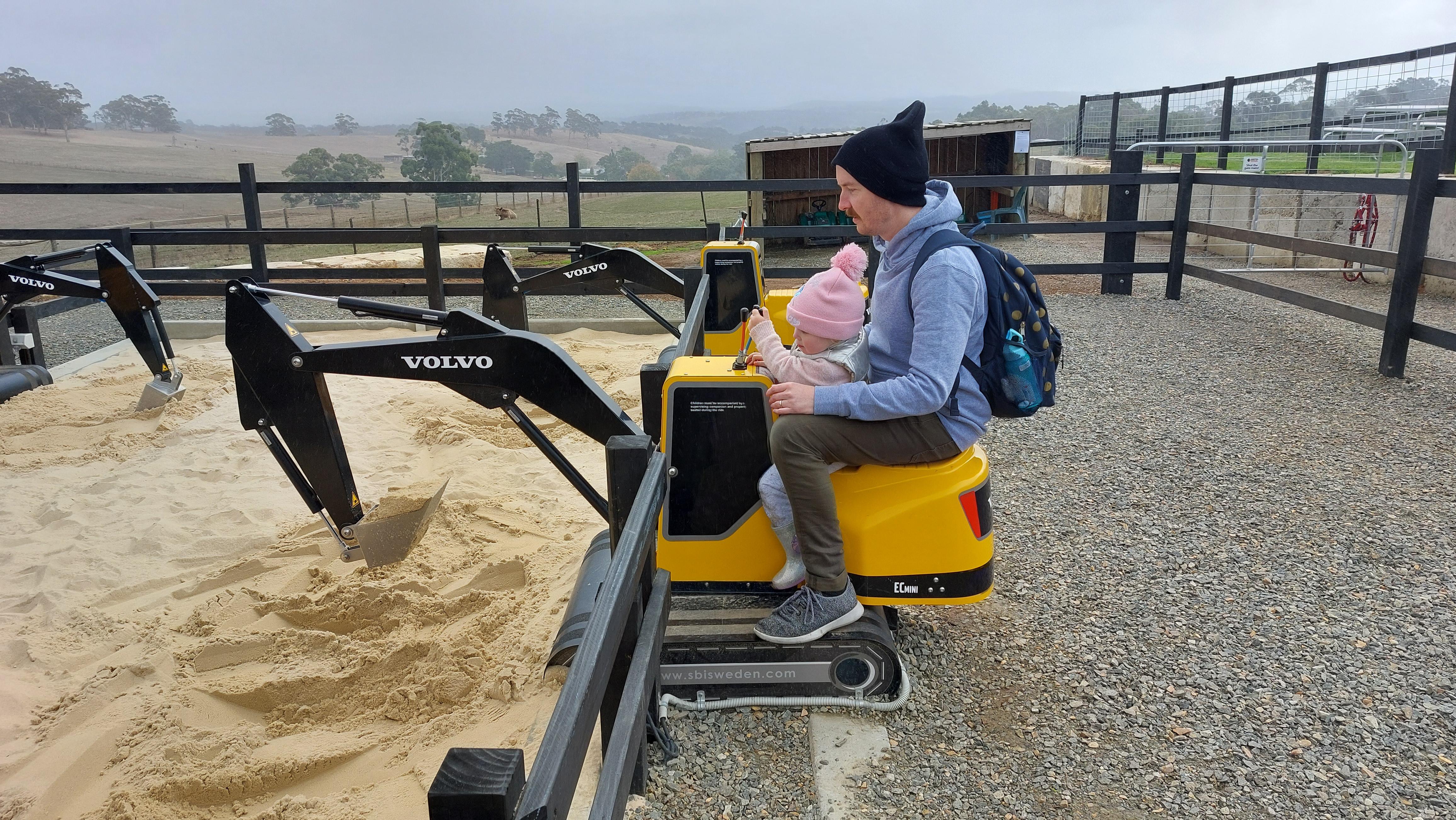 Dad spending time with his daughter on digger