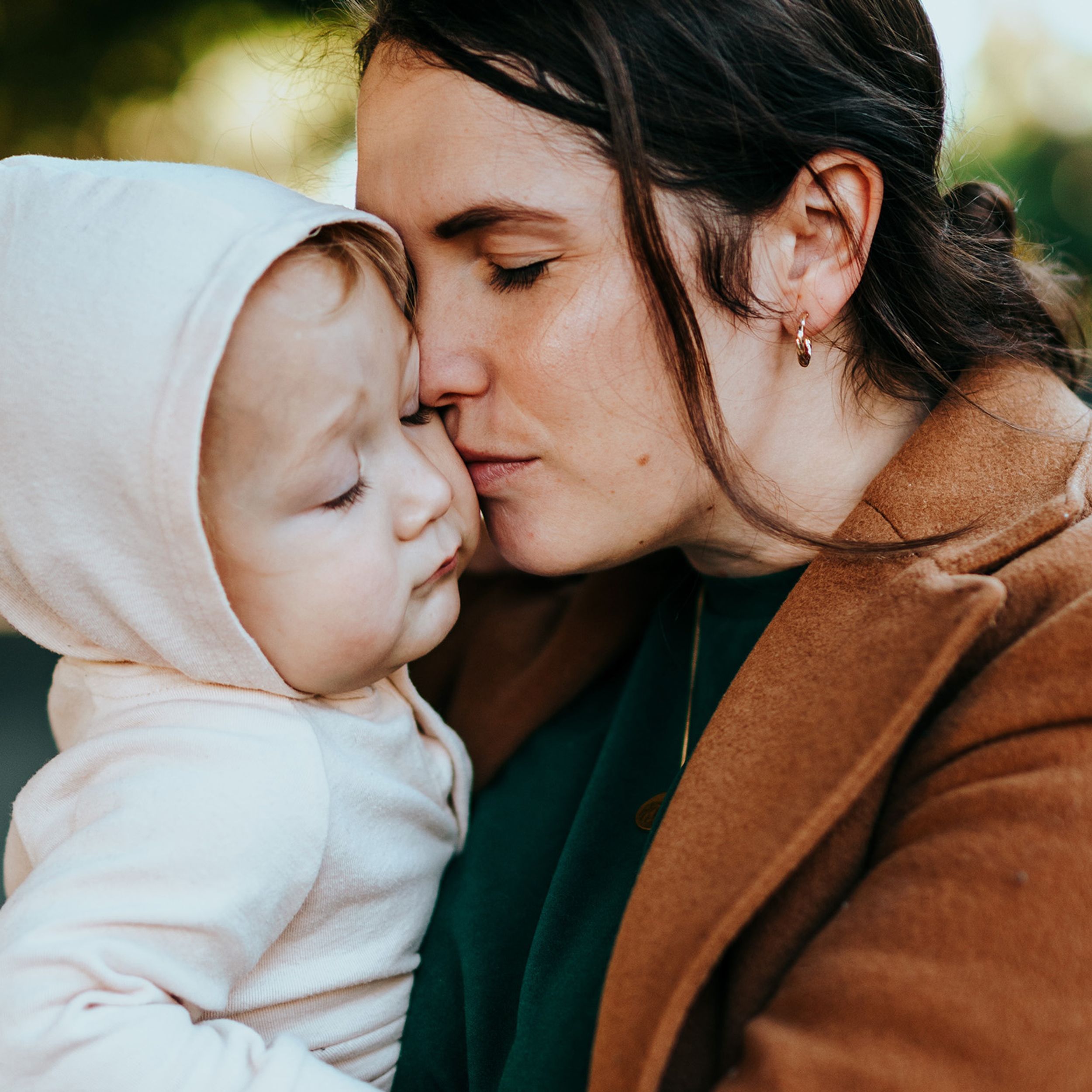 Mother holding baby close