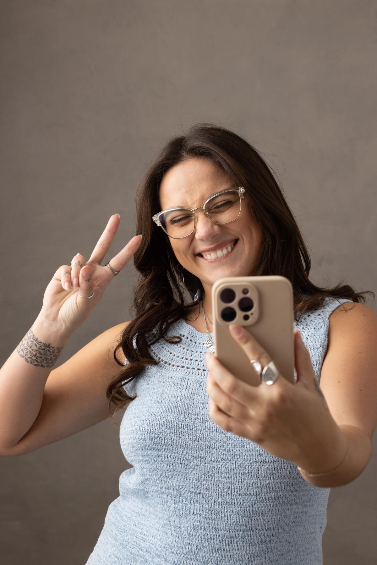 SociaLight Media team member filming social content on her phone