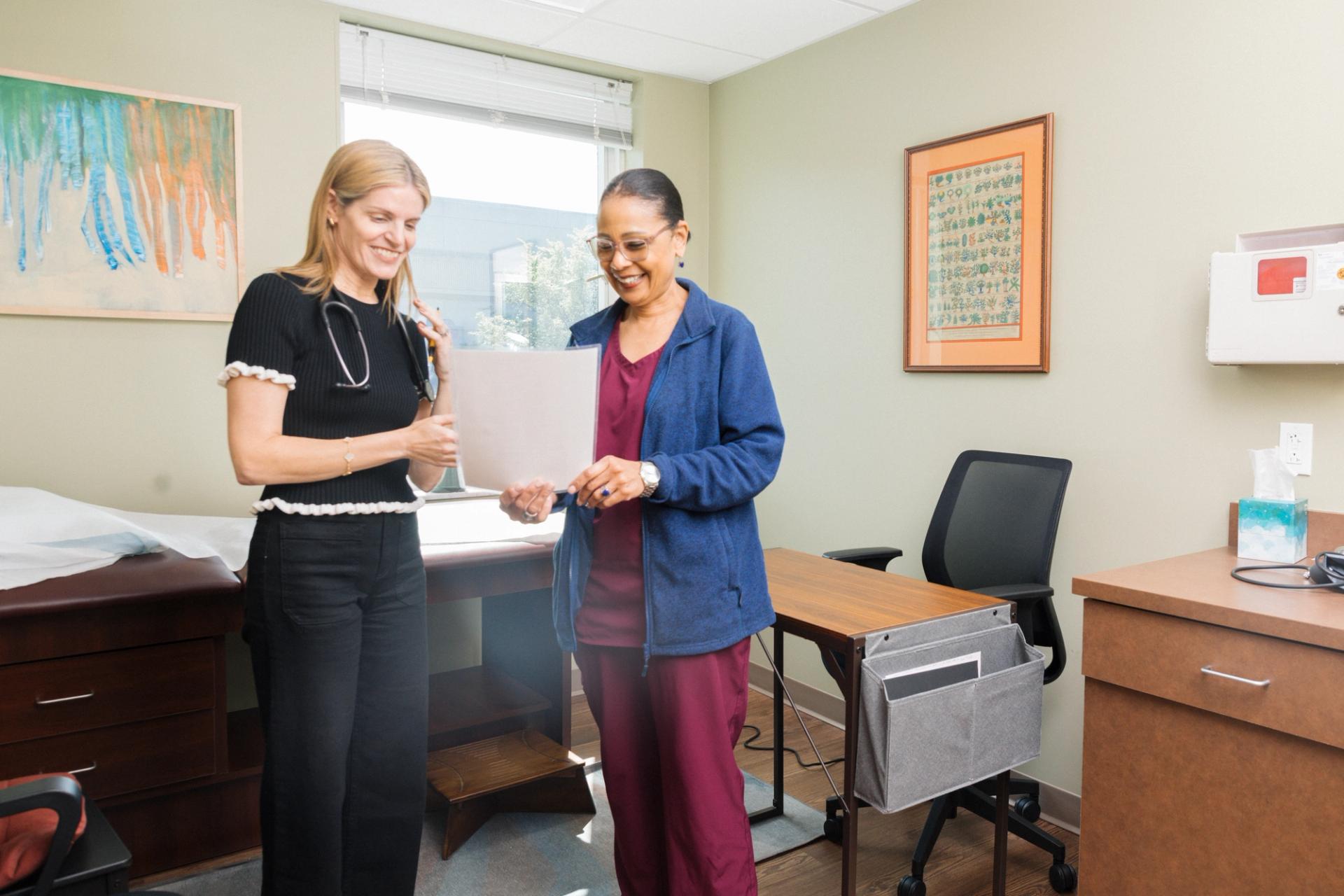 LSR Wellness clinician reviewing notes with a patient in an exam room
