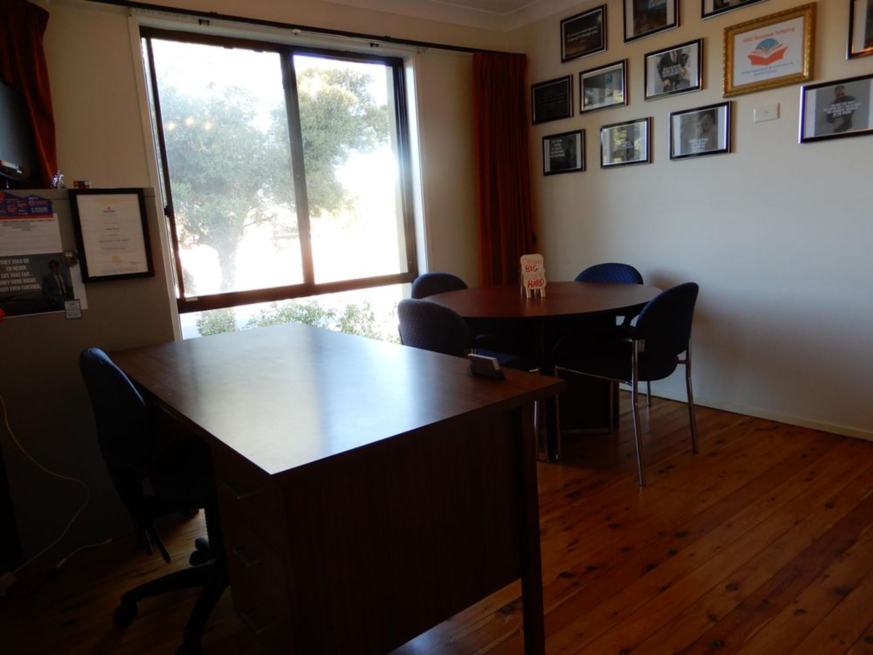 a conference room with a table and chairs in front of a window .