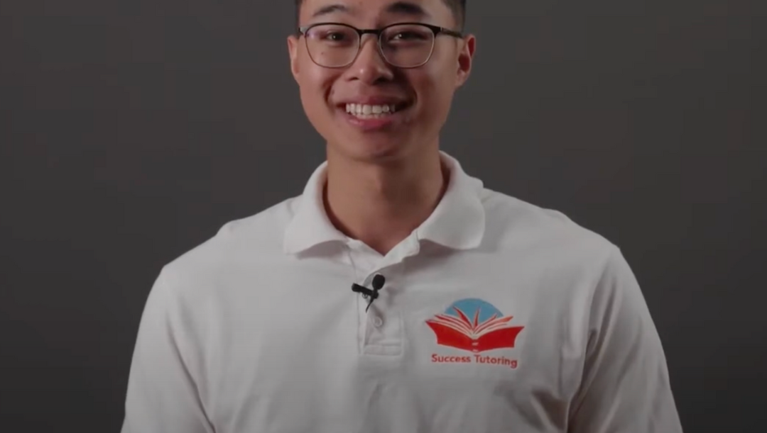 a man wearing a white shirt that says success tutoring