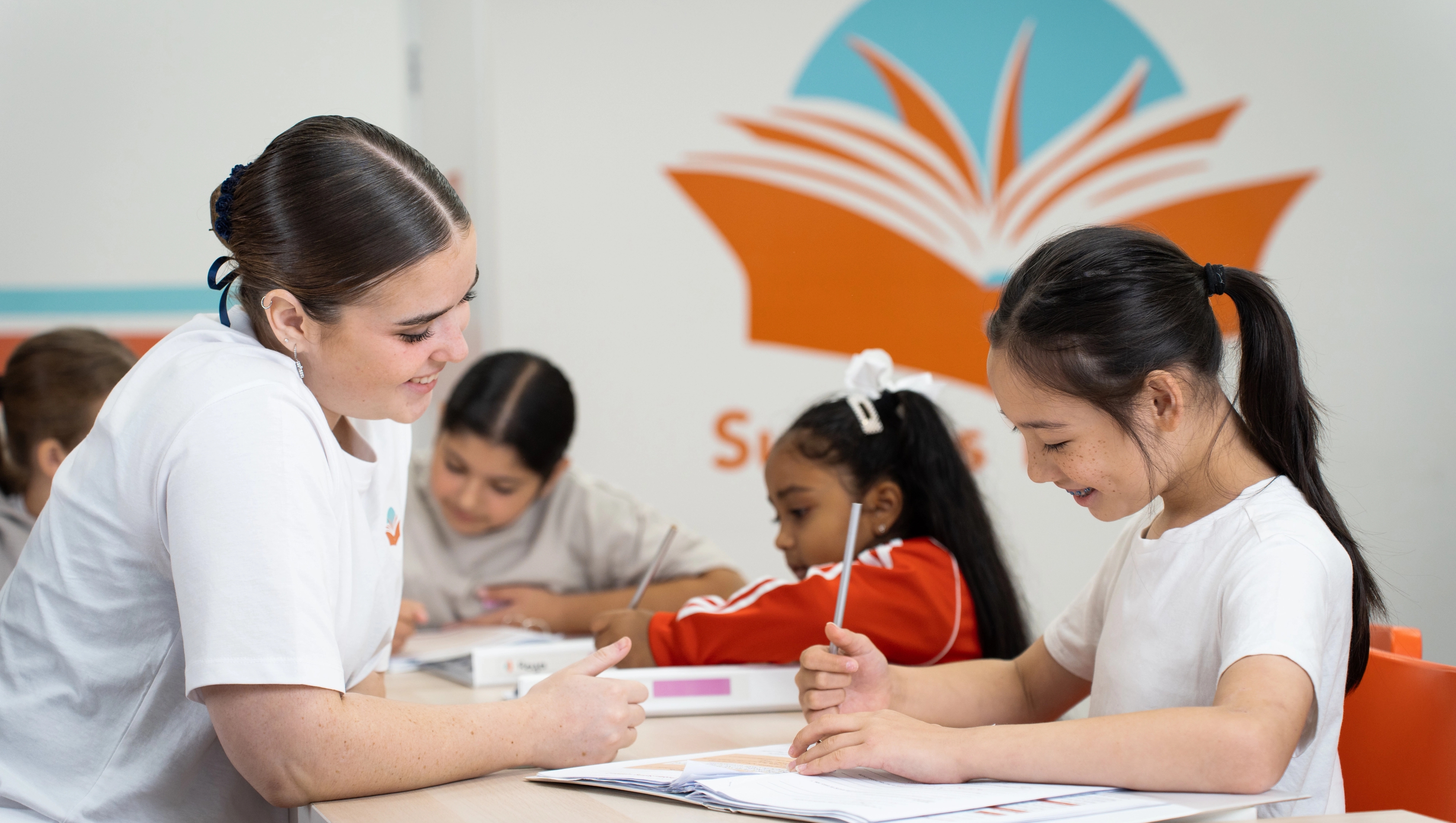 A tutor helping students one-on-one