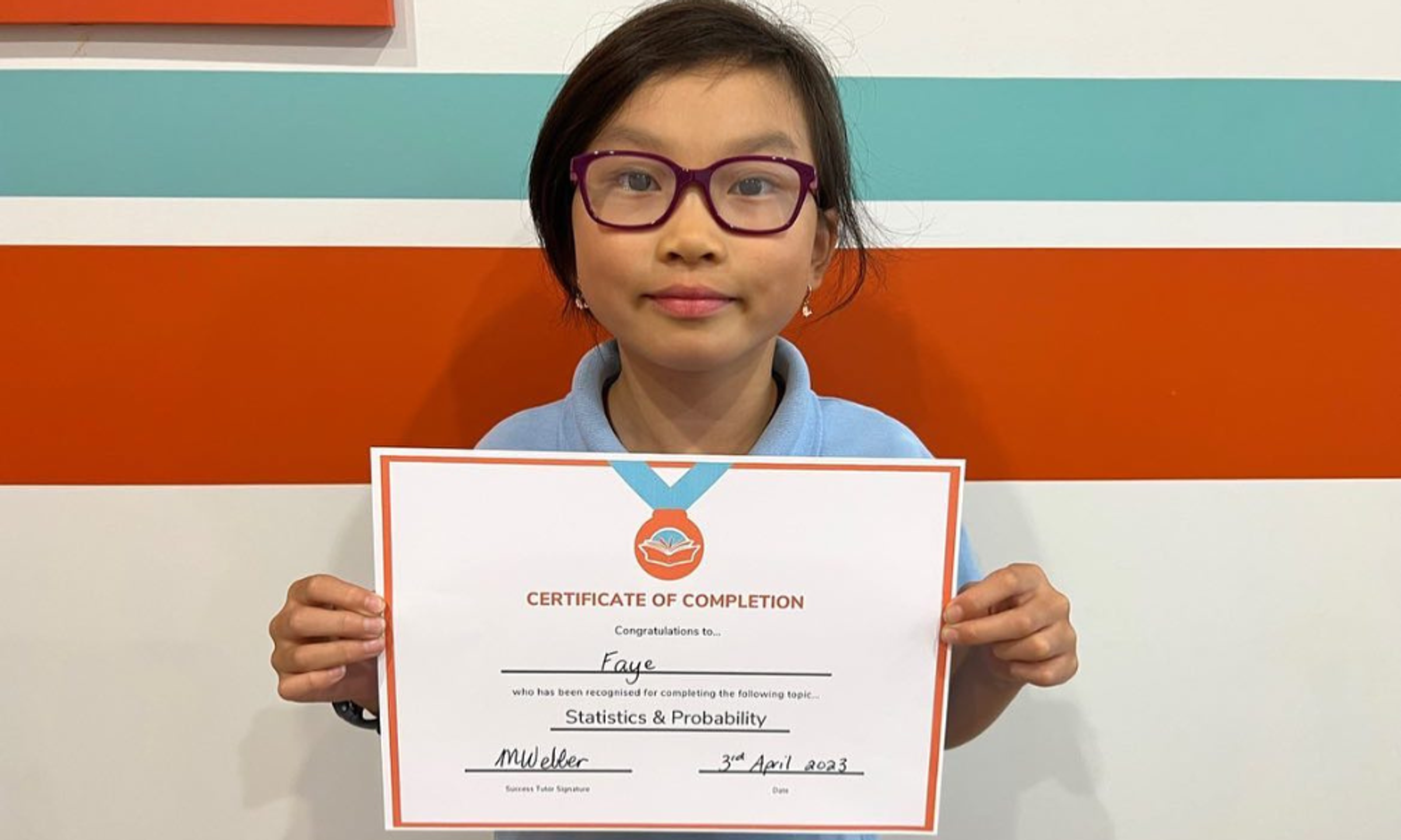 Student holding a Success Tutoring certificate