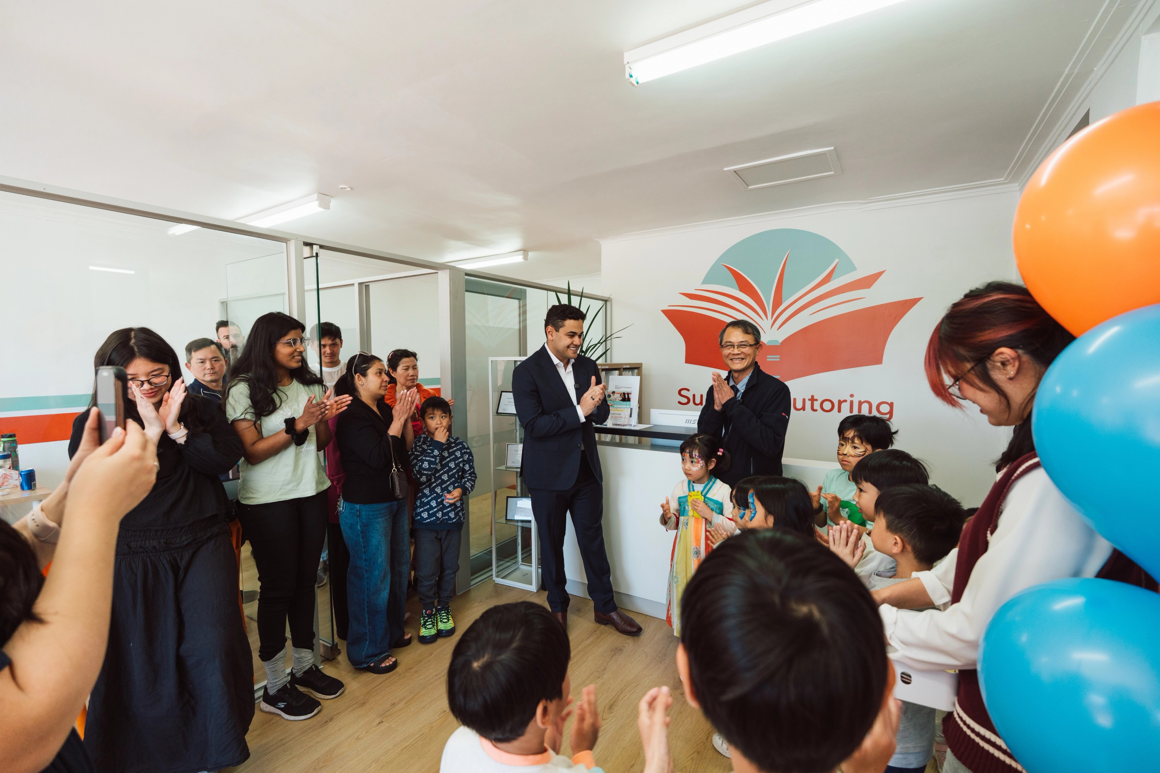 A mother and two children smiling at a Success Tutoring centre