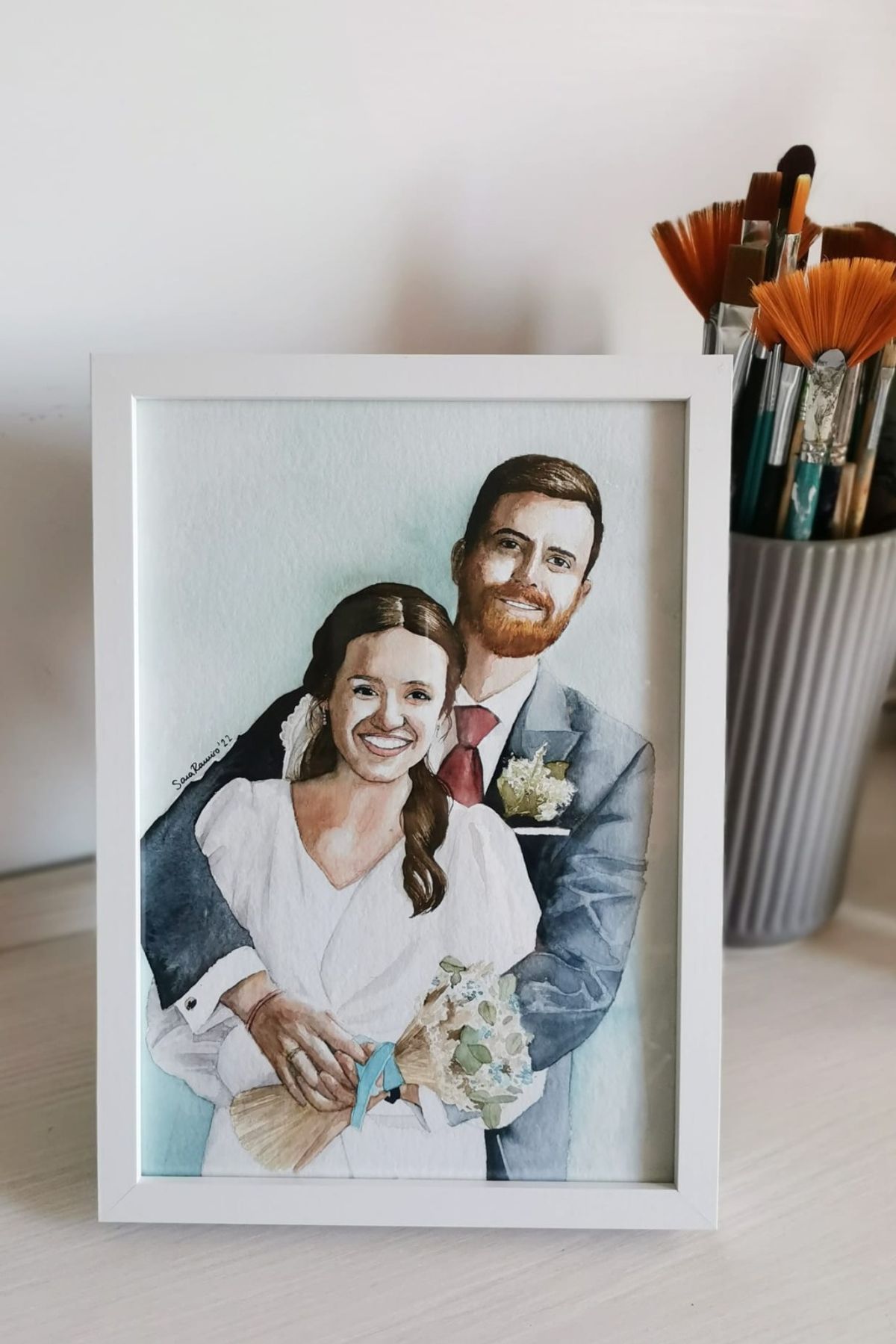 Retrato en acuarela enmarcado de una pareja de novios