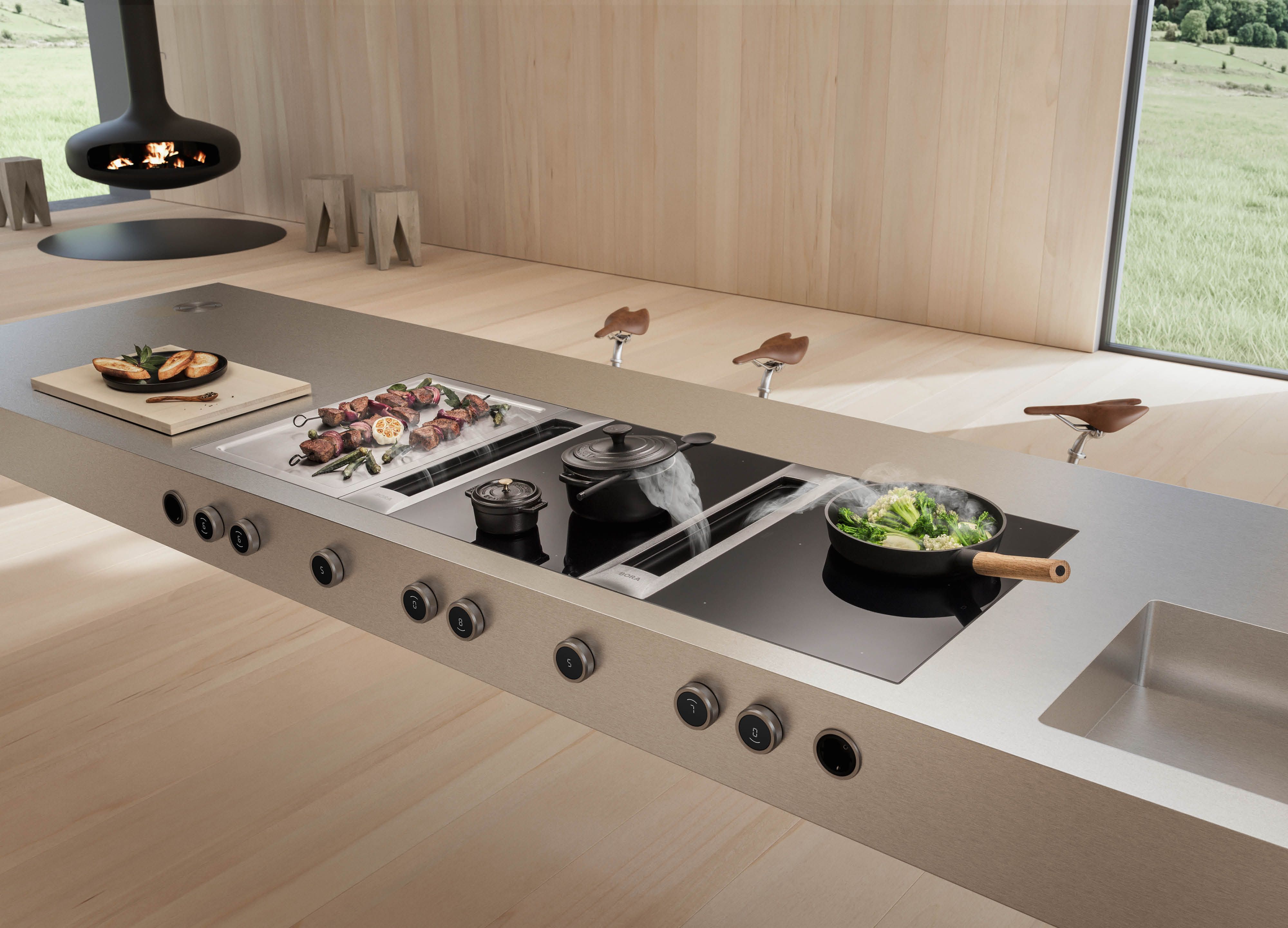 BORA Professional 3.0 Kochfeldabzugssystem in luxuriöser Küche mit Holzboden und Kaminofen im Hintergrund.