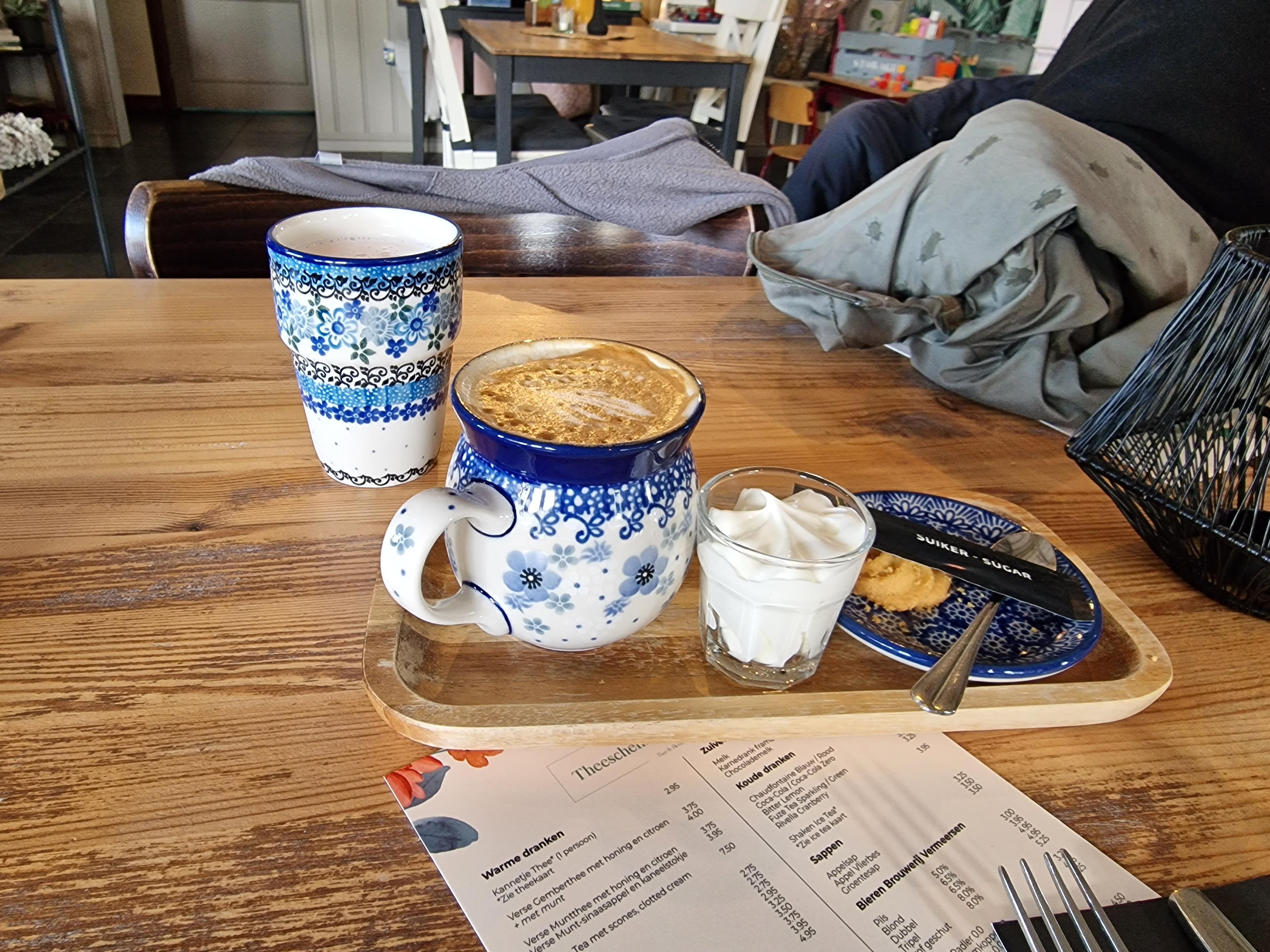 Delicious cappuccino with whipped cream in old Dutch crockery