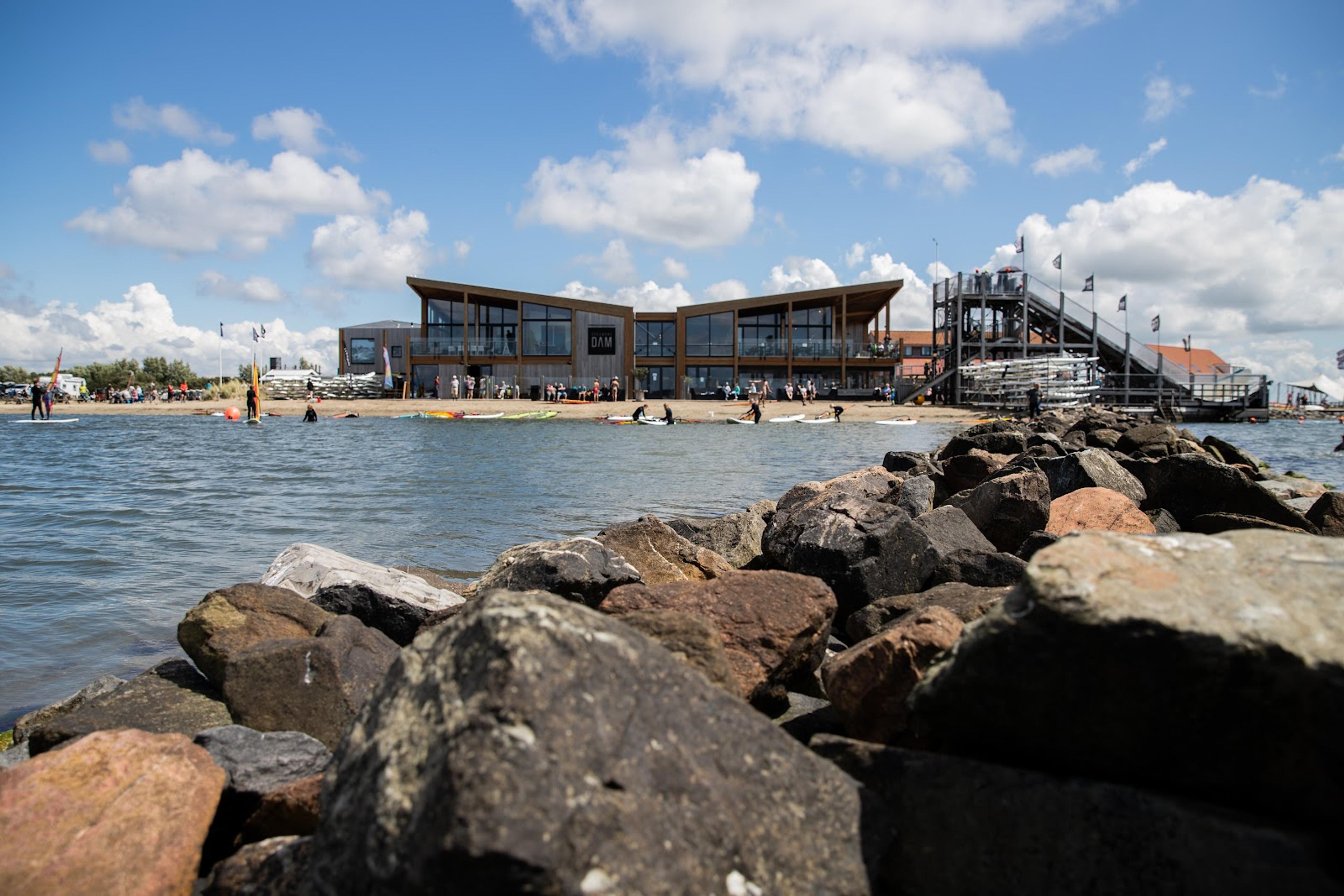 Photo of the waterfront building with water sports enthusiasts