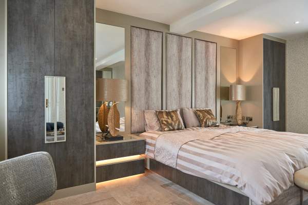 Bespoke fitted wardrobes with panelled doors in a Cheshire bedroom