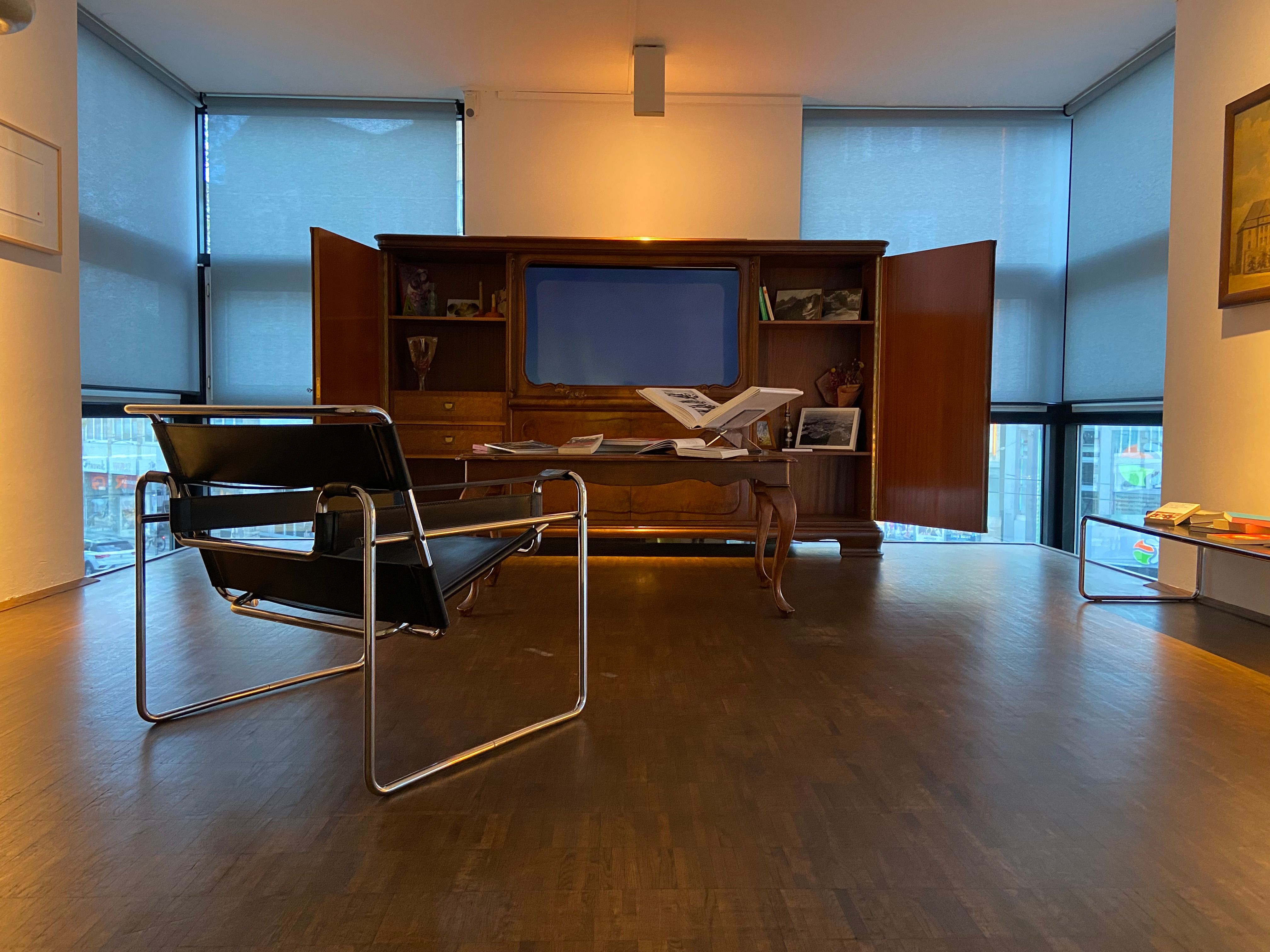 Stuhl vor einem geöffneten Schrank mit Fernseher