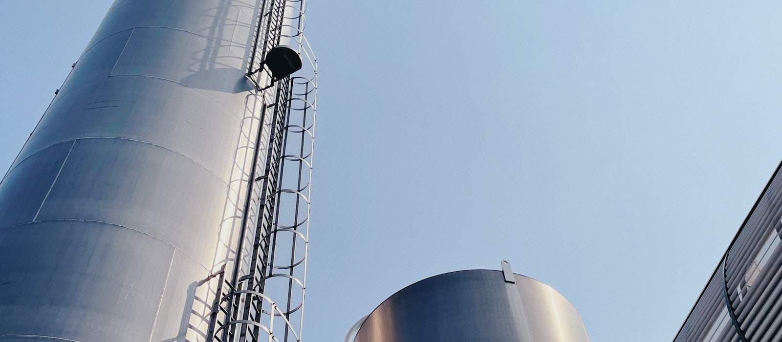 Gökyüzüne yükselen merdivenli endüstriyel metal silolar
