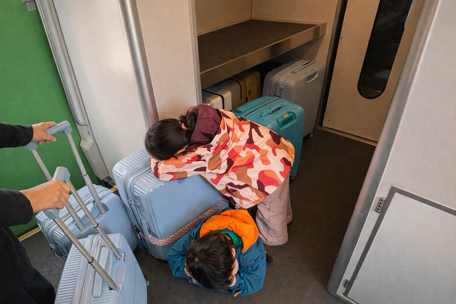 Sleepy kids on a train in Hokkaido on their way to Niseko