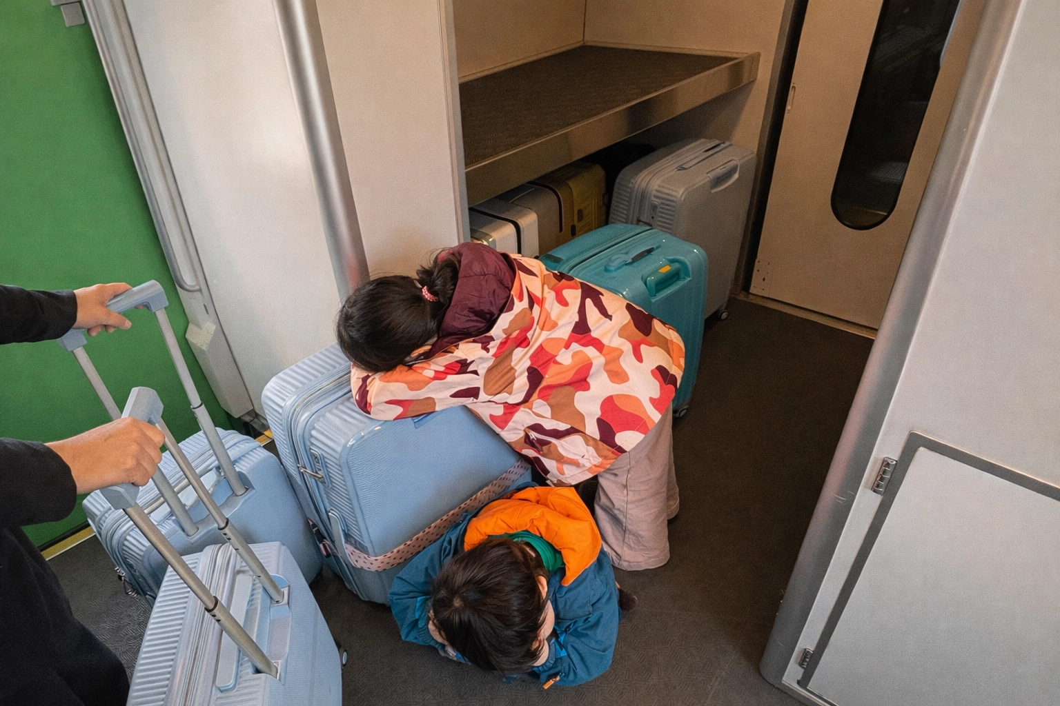 Sleepy kids on a train in Hokkaido on their way to Niseko