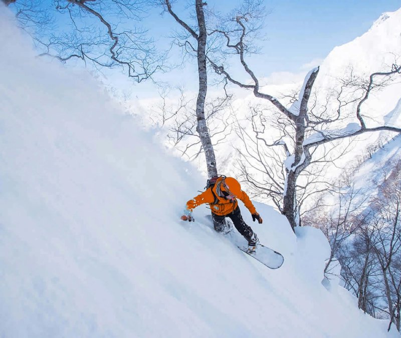 Snowboarder in the backcountry in Gunma putting in some big turns