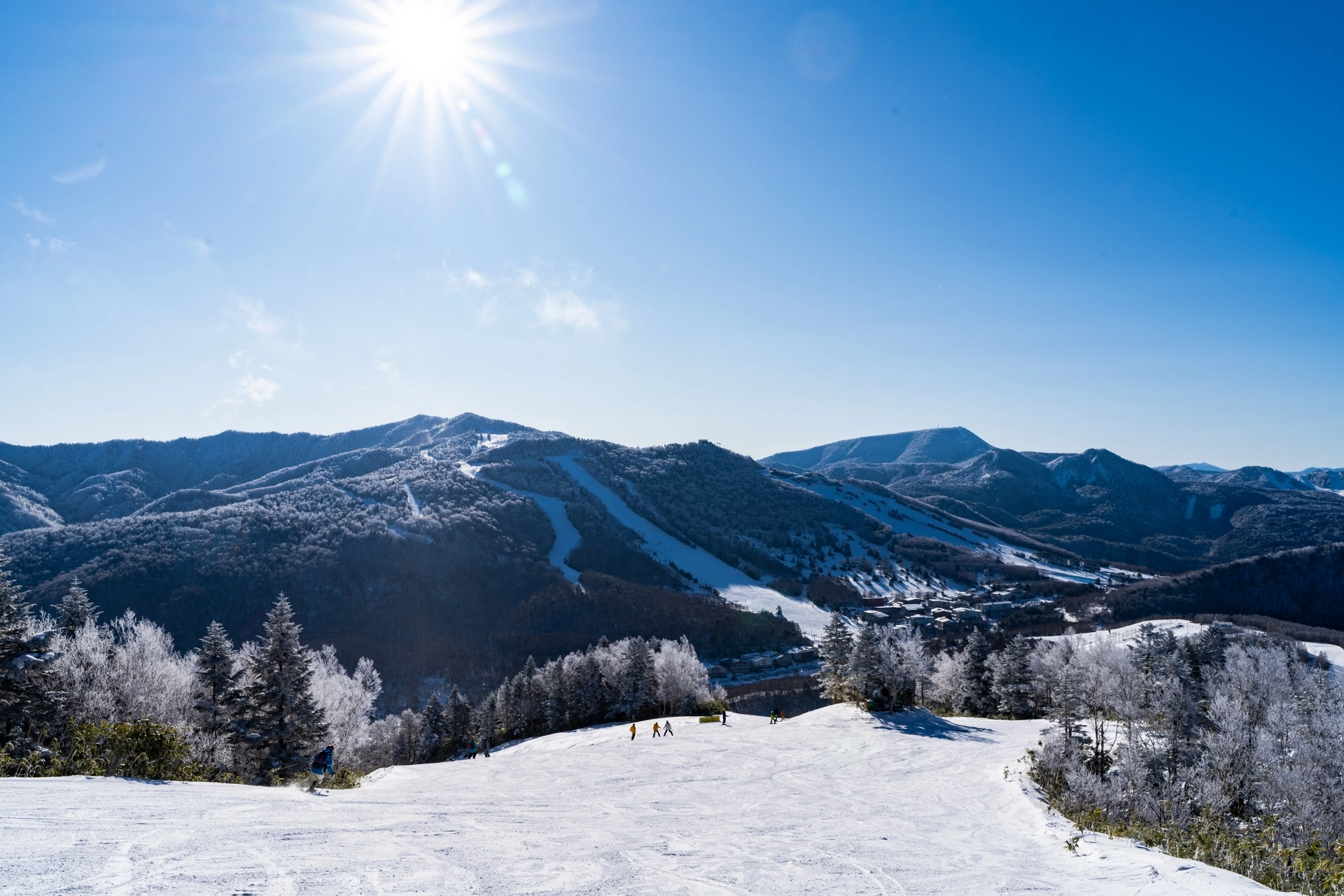 blue sky day at Shiga Kogen overlooking an empty ski run