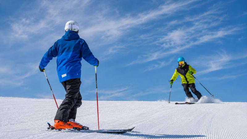 Ski instructor giving an English ski lesson on a snowy Japanese mountain