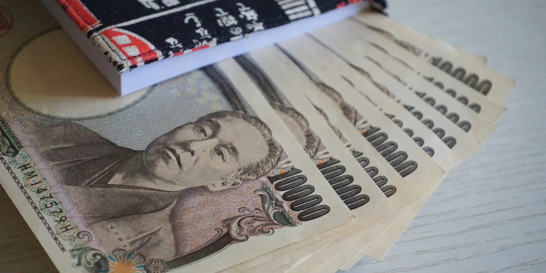 Japanese Yen notes fanned out in a book