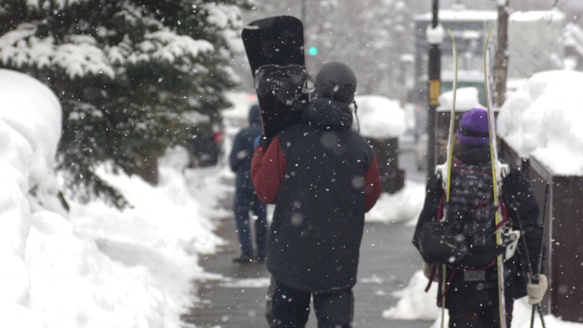 snowboarder walking the streets of Niseko in the snow