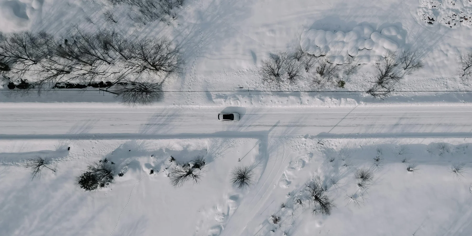 Top down view of a car driving in Hokkaido