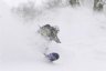 Snowboarder in powder at Esashi Shiei Koeji