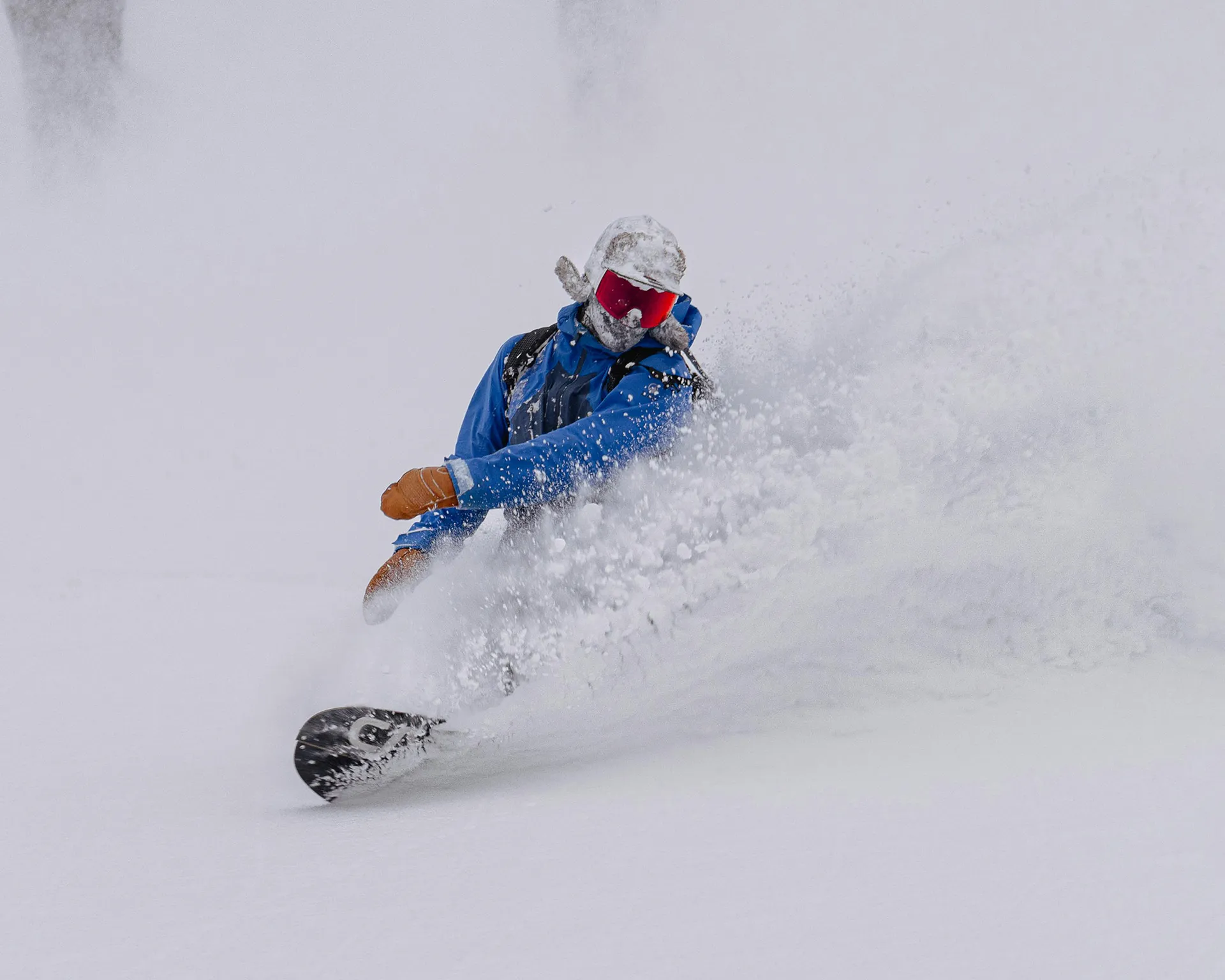 snowboarder making big japow turns | Nagano area