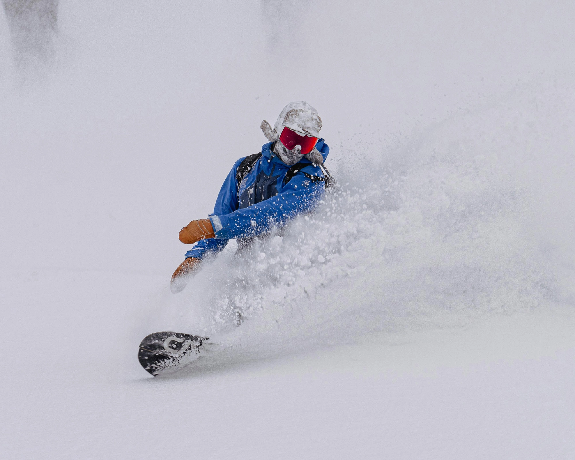 snowboarder making big japow turns | Nagano area