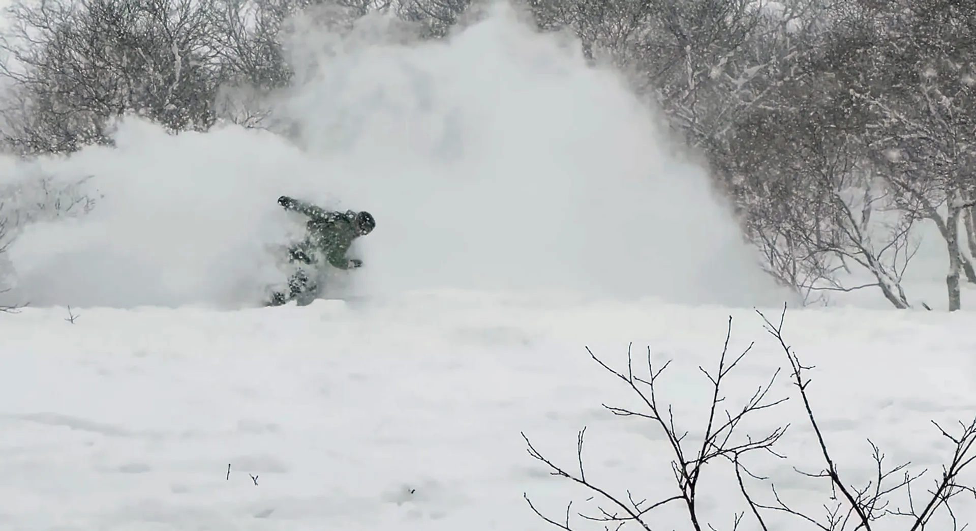 Snowboarder at Annupuri in the trees