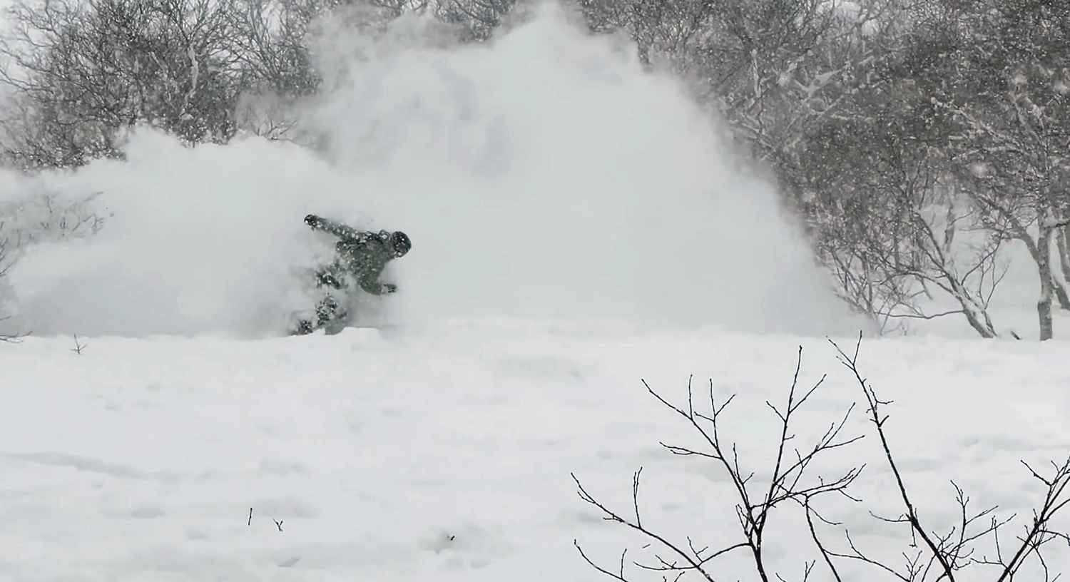 Snowboarder at Annupuri in the trees