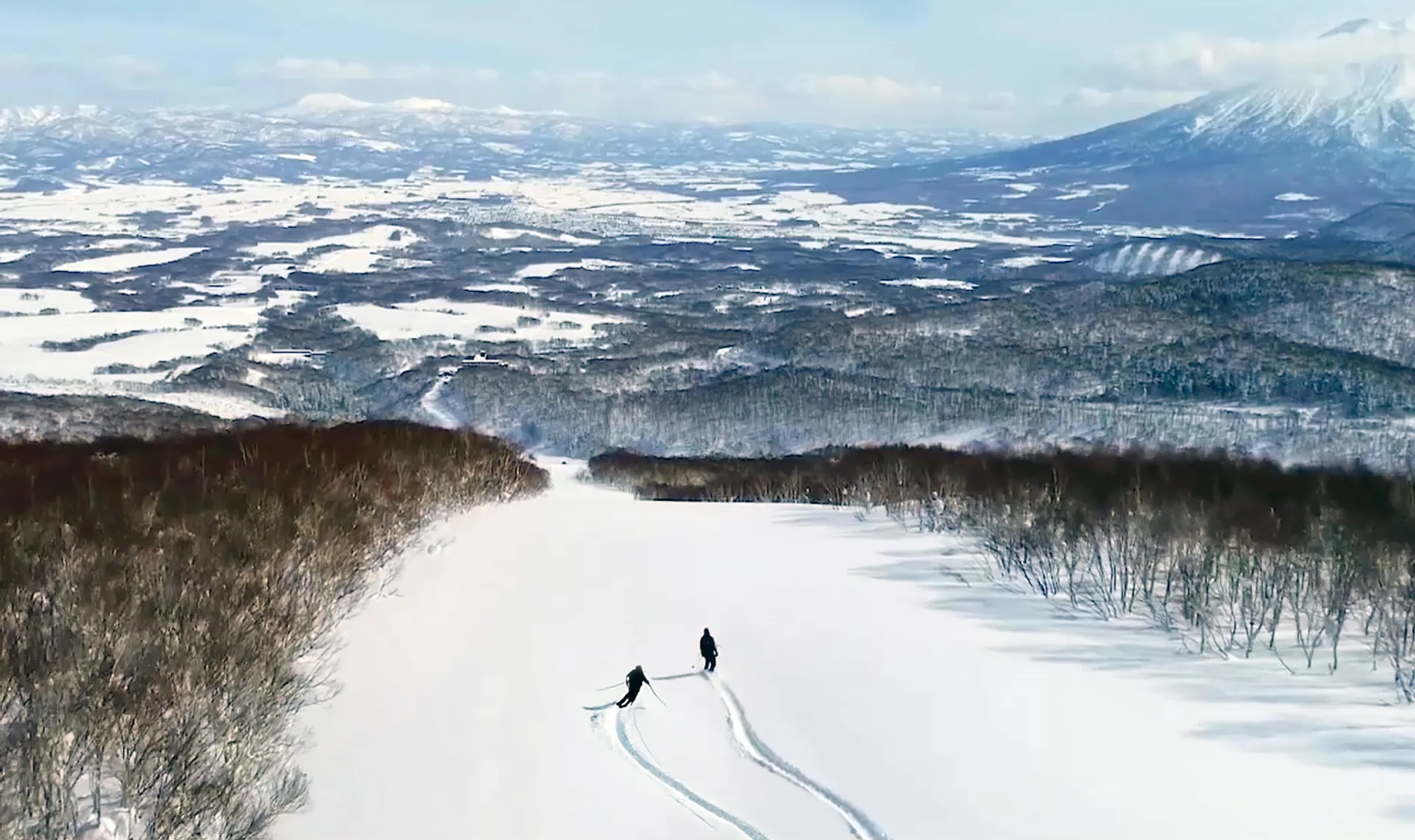Hanazono skier and snowboarder enjoying an empty run of fresh pow