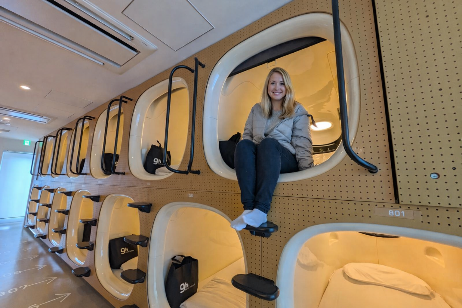 Girl sitting in her Capsule accommodation