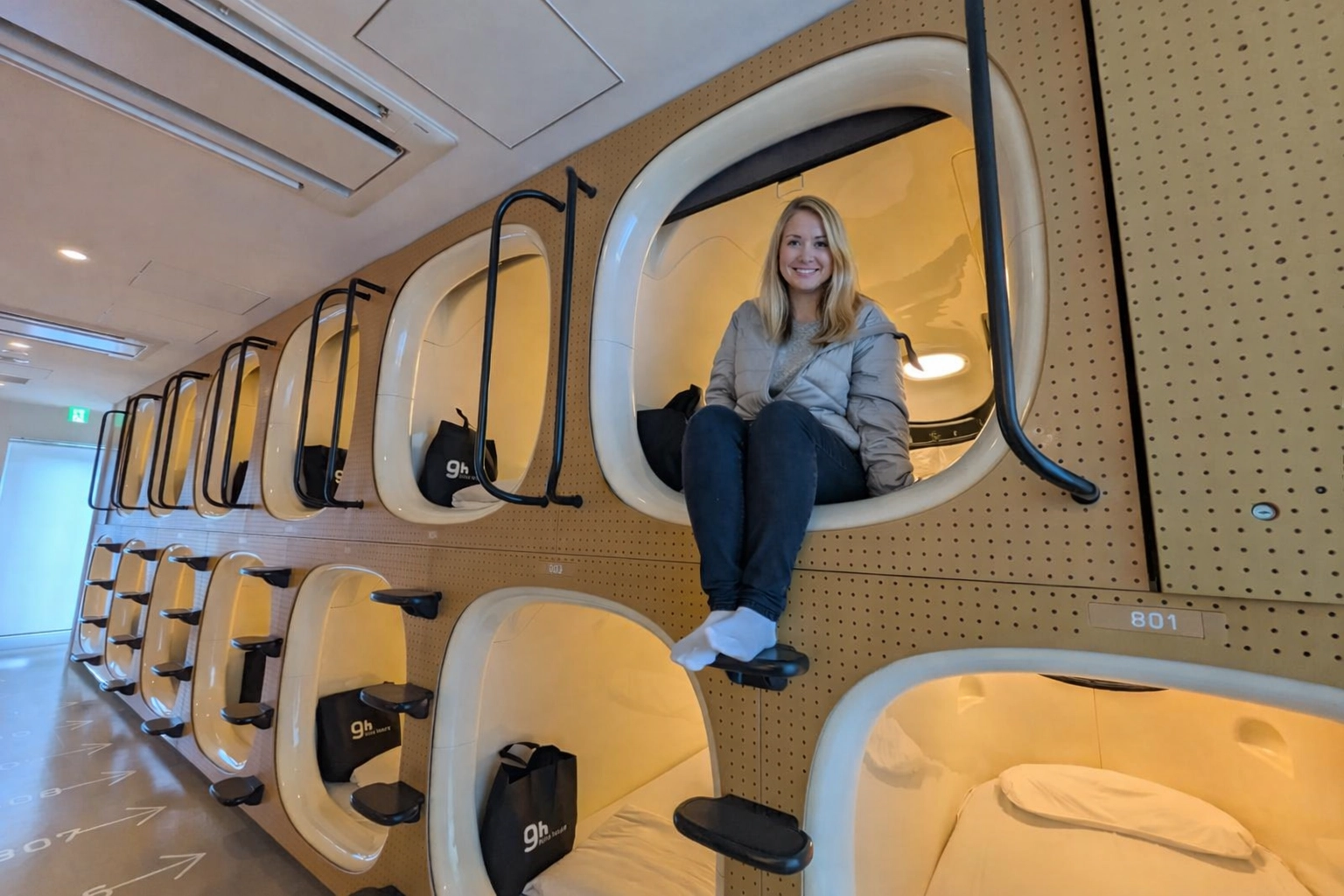 Girl sitting in her Capsule accommodation