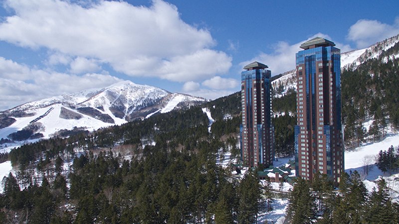 Views of hotel towers in front of ski runs in the background