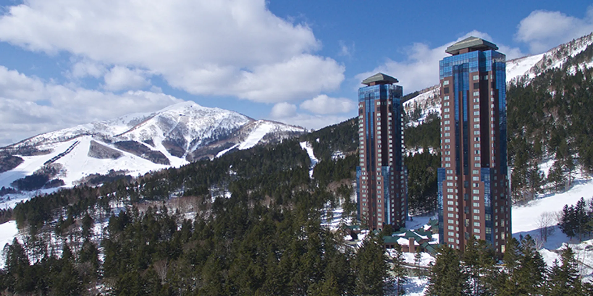 Views of hotel towers in front of ski runs in the background