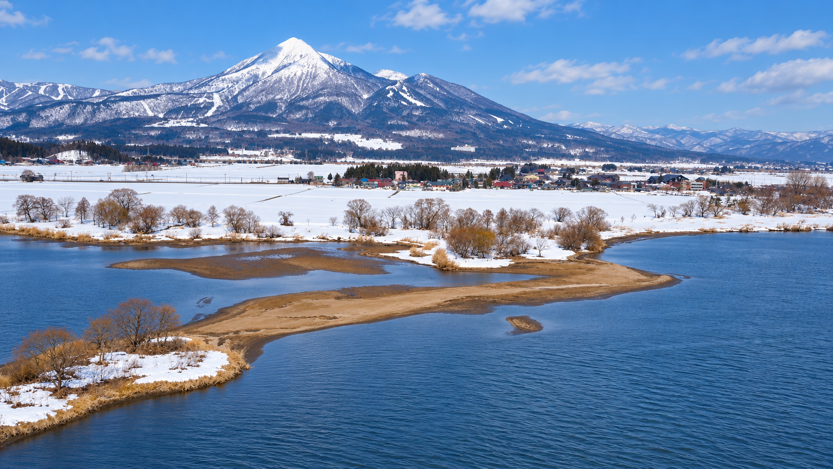 View of the Inawashiro valley and lake with mountains in the background