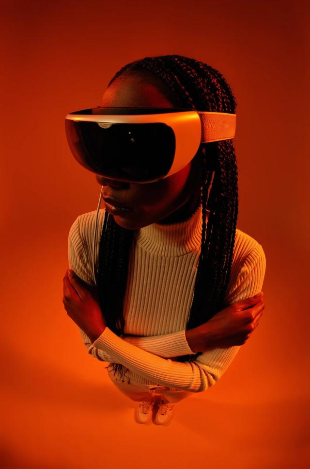 Top-down portrait in saturated orange studio light