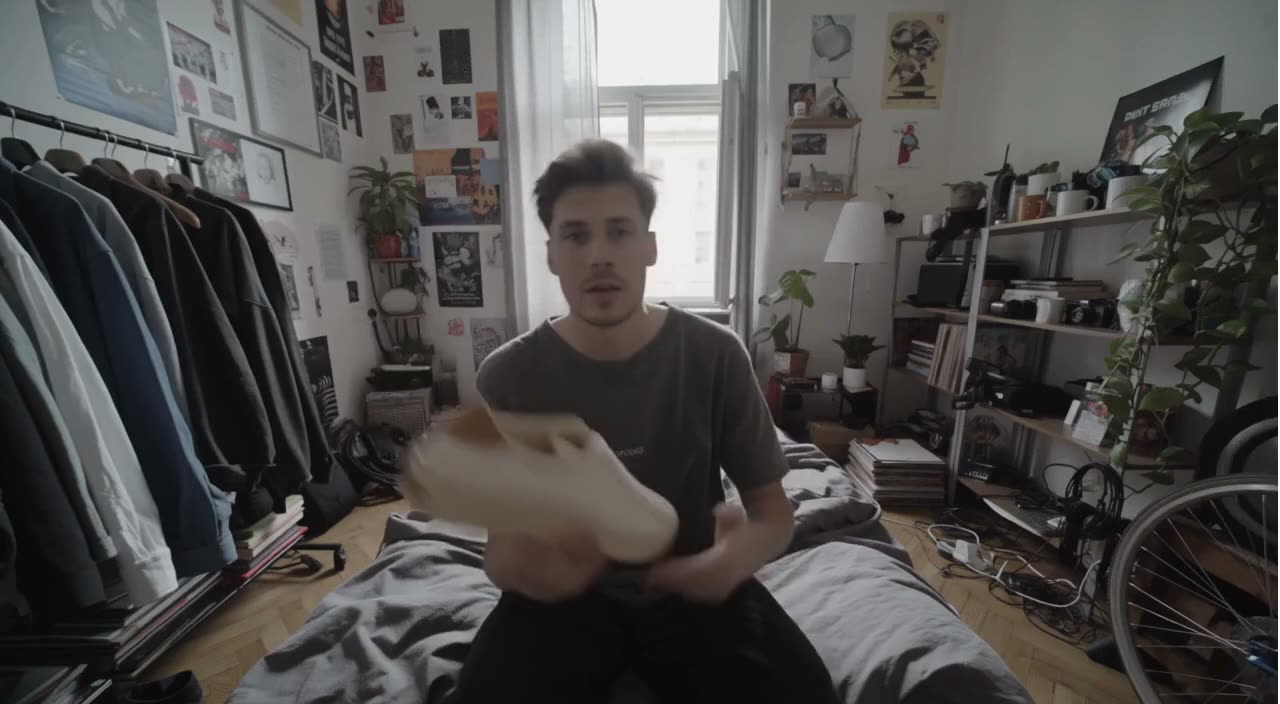 A sneaker held up to the camera