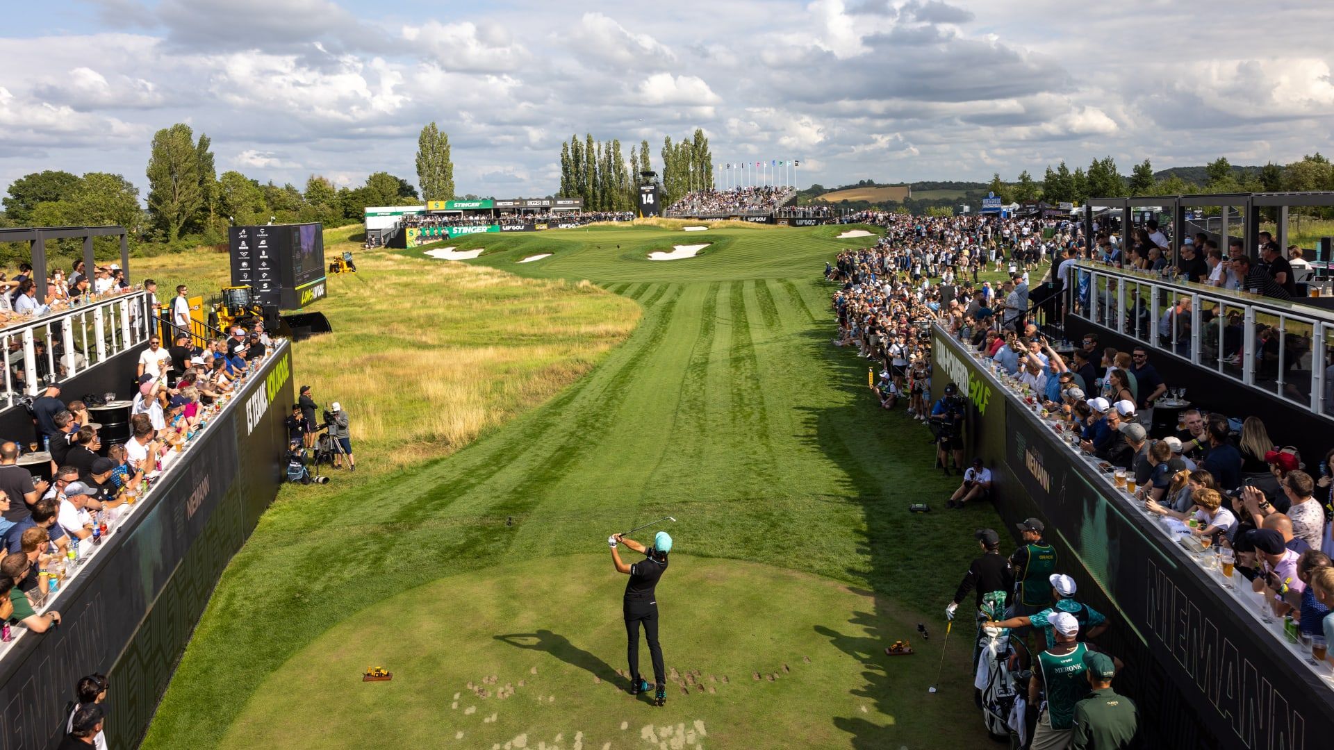 Golfers competing at a tournament with crowds watching