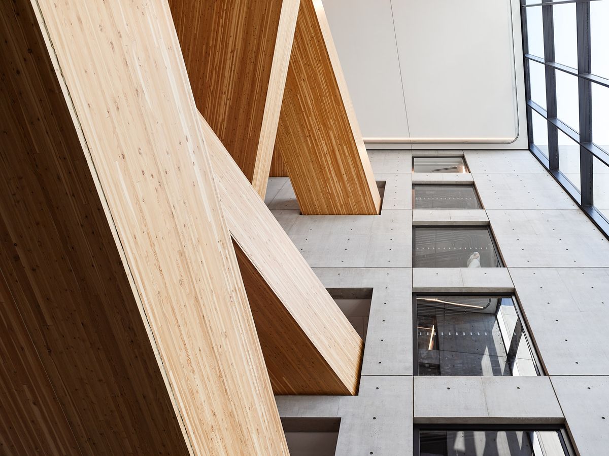 Looking up at the mass timber wooden stair case in a modern commercial building.