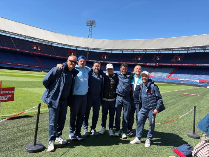 Italian coaches next to pitch during stadium tour