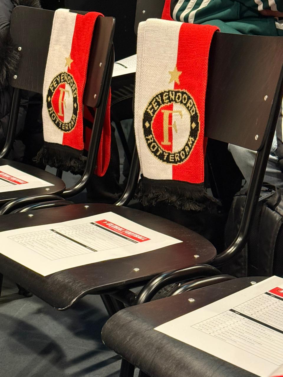 Scarfs and programs on the chair for the Academy Visit