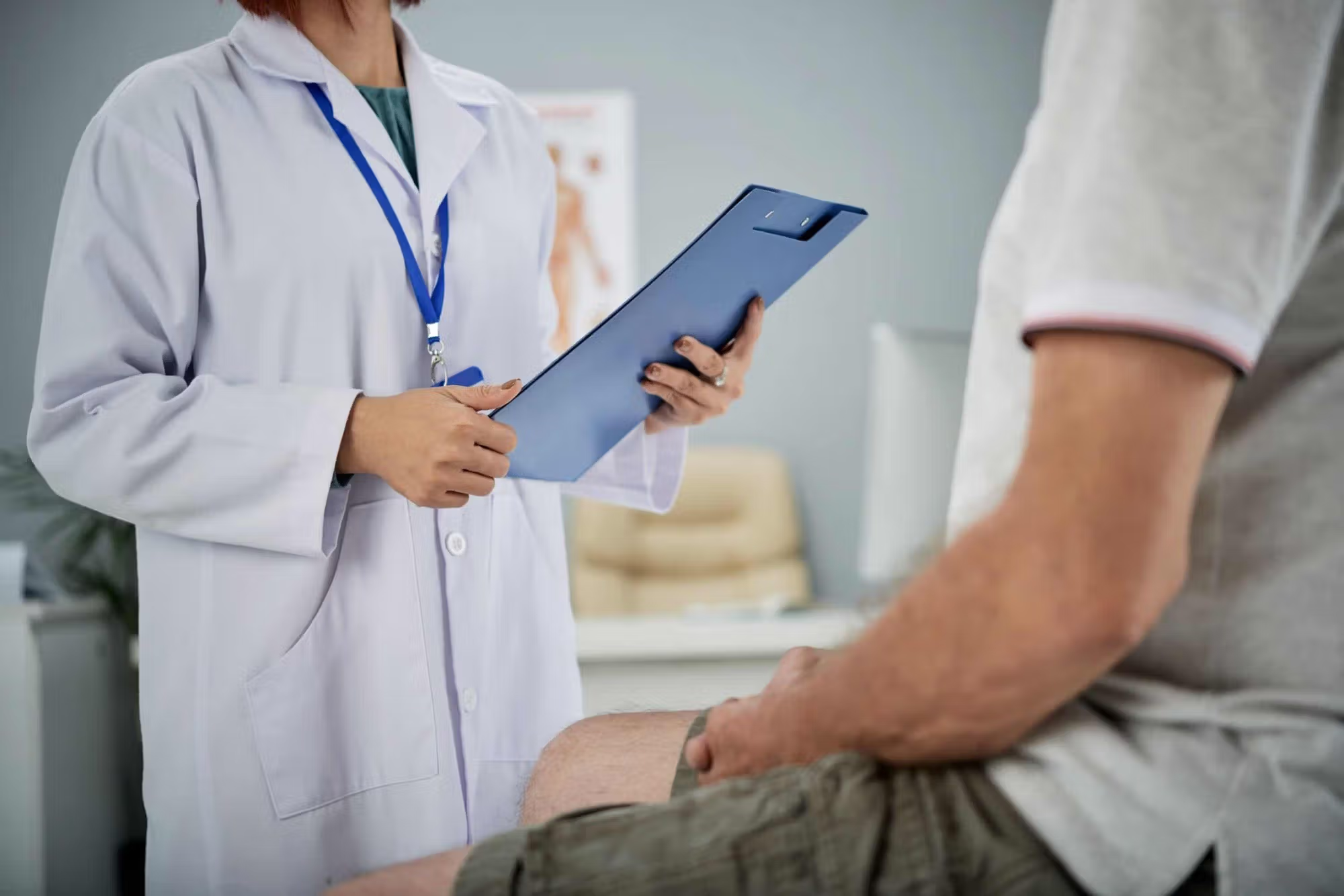 doctor speaking to am ale patient about a pre existing condiiton becoming a disability after a truck accident